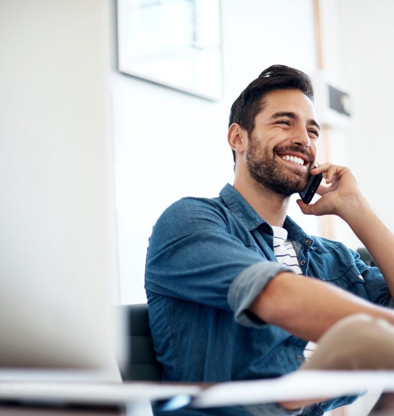 Cropped shot of a young designer talking on a cellphone in an office